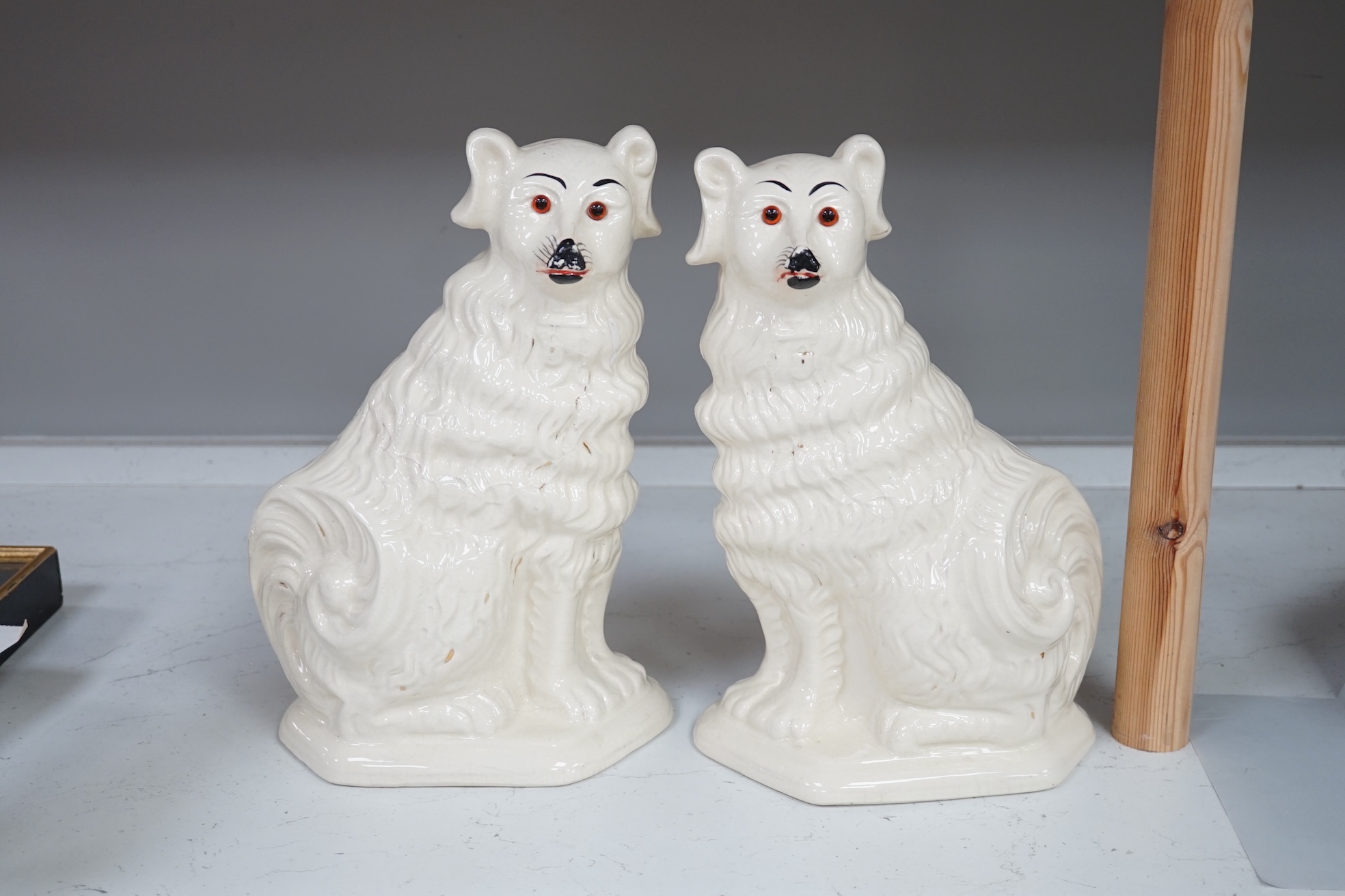 A pair of rare Staffordshire models of collies and a Victorian pottery models of a spaniel, tallest 34cm. Condition - fair to good.